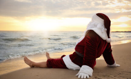 Santa Claus relaxing on beach, space for text. Christmas vacation