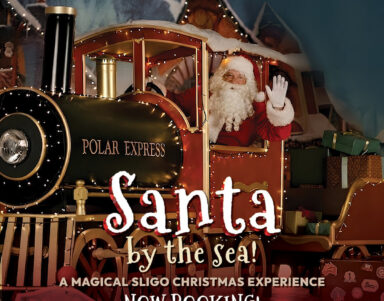 Santa on festive train at magical Sligo Christmas event, surrounded by gifts and holiday decor, inviting atmosphere.