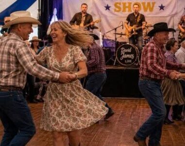 Guests enjoy lively country music and dancing under a vibrant festival marquee with live band at Enniscrone Hotel.