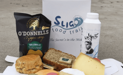 Indulge in a seaside picnic with local cheese, artisan bread, and gourmet treats, showcasing Ireland's culinary delights.